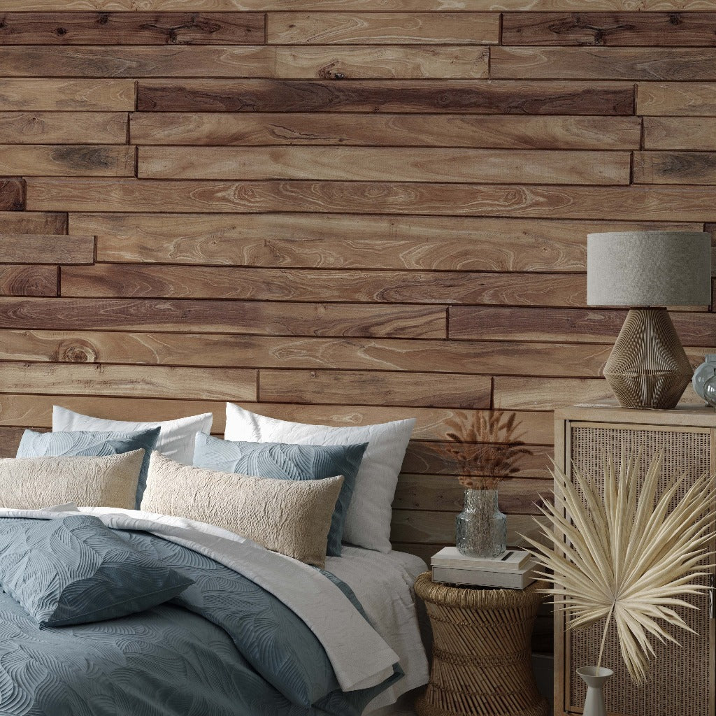 Bedroom - A cozy bedroom featuring a bed with gray and white bedding, Decor2Go Wallpaper Mural rustic wood mural, a bedside table with a lamp, and decorative dried plants.