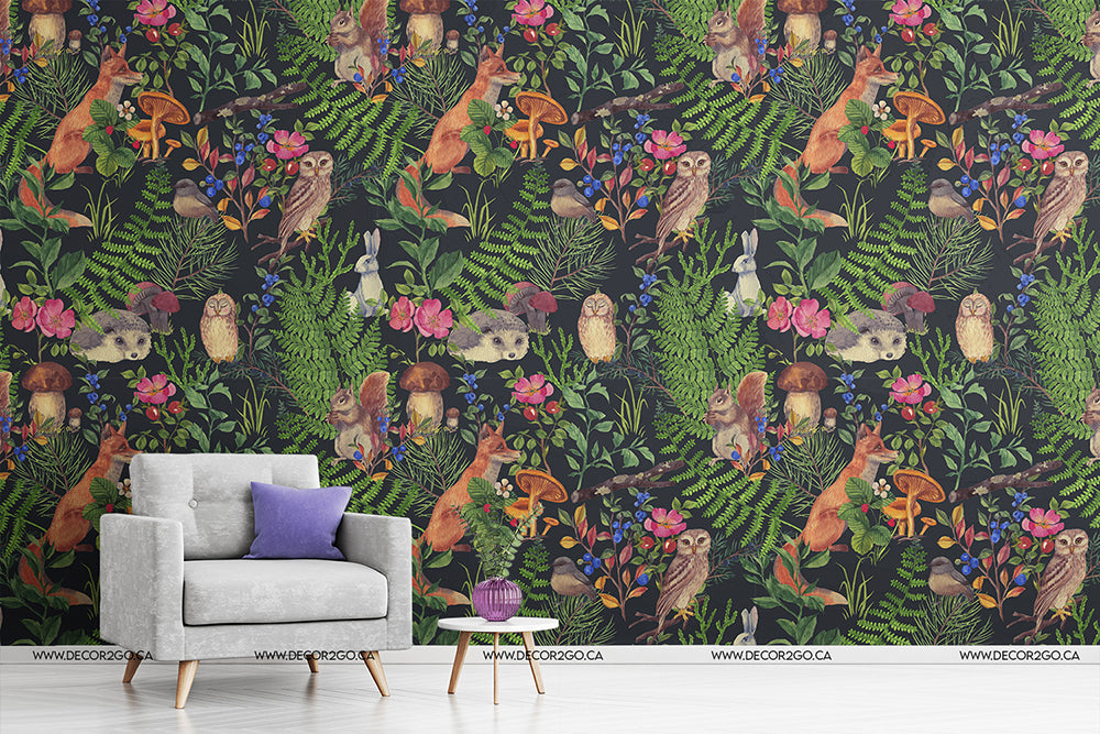 A stylish interior with a Woodland Wonder Wallpaper Mural from Decor2Go featuring birds and lush foliage is transformed into a feature wall decor. A modern gray chair with a purple cushion and a small wooden side table with a plant are