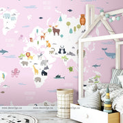 Bedroom - A child's bedroom with World Map with Wild Animals Pink wallpaper mural from Decor2Go Wallpaper Mural featuring arctic and oceanic regions, a white bed frame, and a decorative basket.