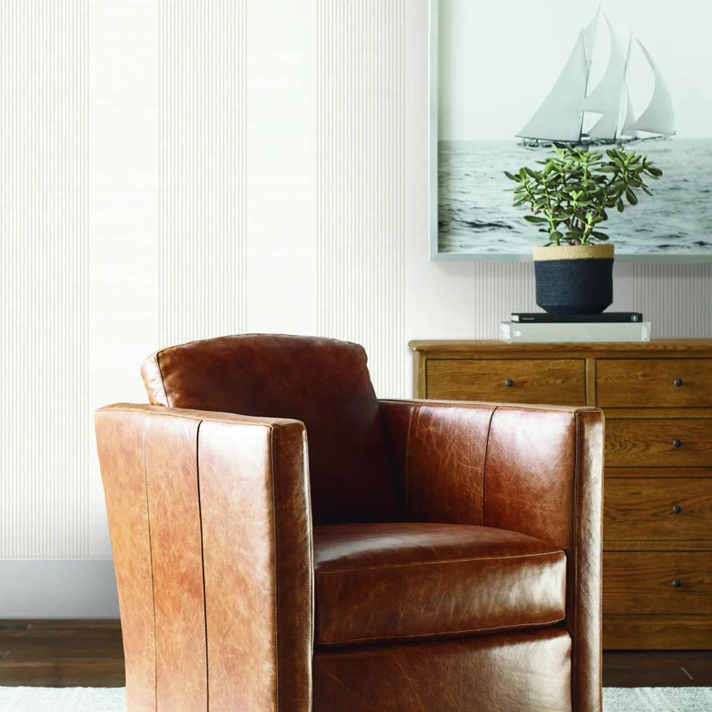 Living room showcasing elegant 'Archer Stripe' wallpaper in Off-white and Beige by York Wallcoverings.