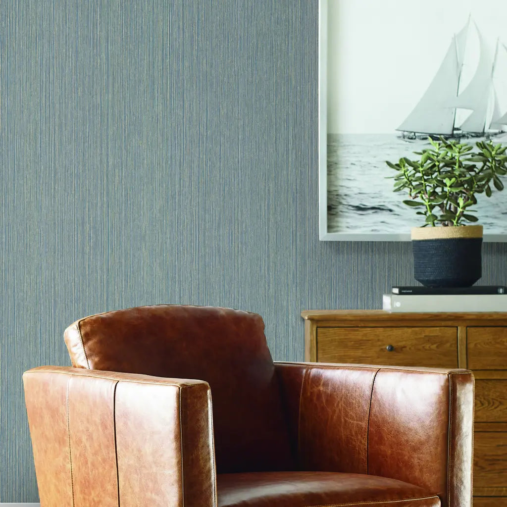 Cozy living room showcases Atticus Slate Blue wallpaper by York Wallcoverings, creating a serene and stylish space.