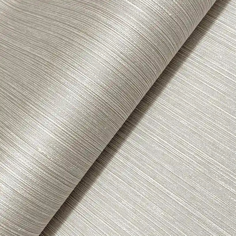 Close-up texture detail of Atticus wallpaper by York Wallcoverings, showcasing its elegant light taupe finish.