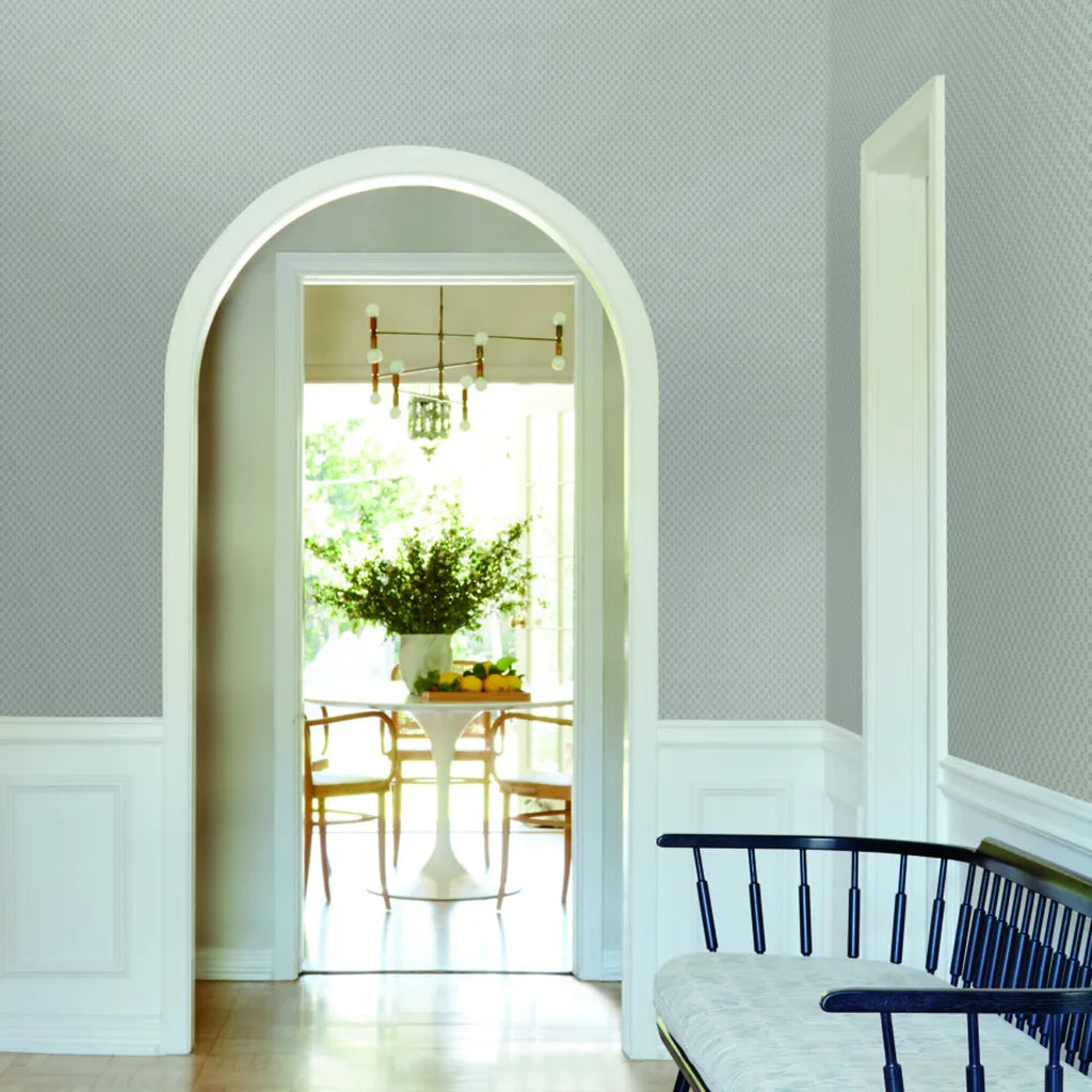 Grey Brioni wallpaper by York Wallcoverings enhances the elegant design of this entryway.