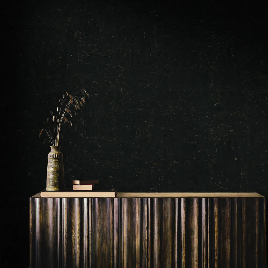 Modern living room features Caldera Cork wallpaper in Black and Bronze by York Wallcoverings, adding sophisticated texture.