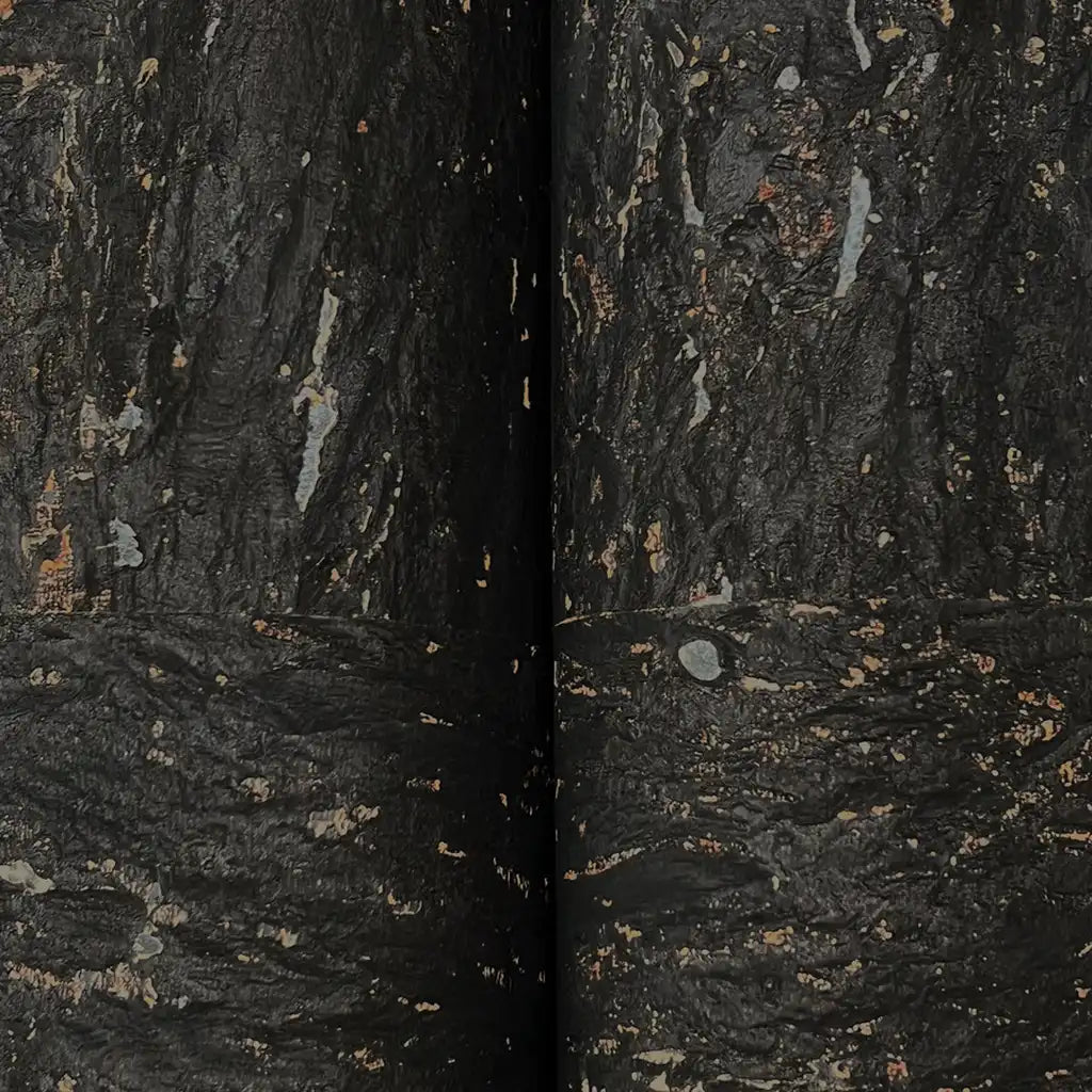 Close-up texture detail of York Wallcoverings' Caldera Cork wallpaper in black and bronze, showcasing its unique surface.