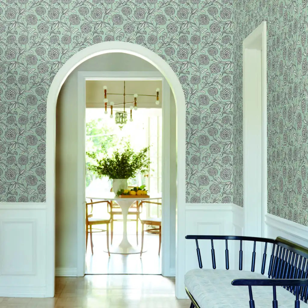 Entryway showcases stunning blue & white 'Chatsworth Garden' wallpaper by York Wallcoverings, creating a vibrant, inviting space.
