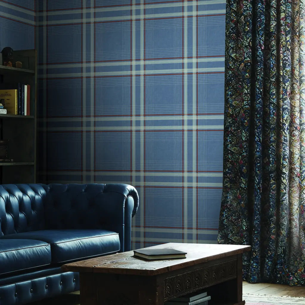 Living room showcases classic Country Club Plaid wallpaper in Dusty Blue by York Wallcoverings, creating a refined atmosphere.