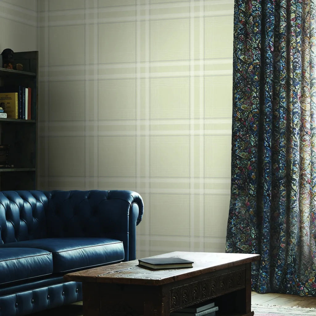A stylish living room featuring classic Country Club Plaid wallpaper in Warm Ivory from York Wallcoverings.