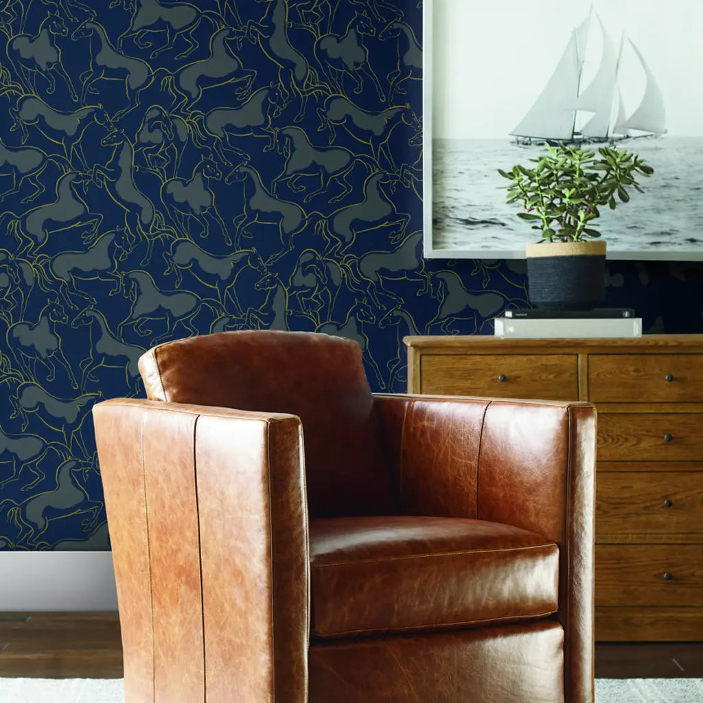 Luxurious living room with York Wallcoverings' Dressage wallpaper in striking navy, grey, and gold.