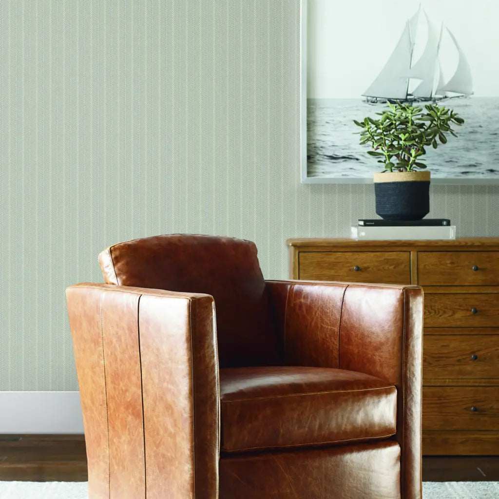Living room showcases York Wallcoverings' Elkan Stripe wallpaper in Greige and Grey, bringing modern style and sophistication.