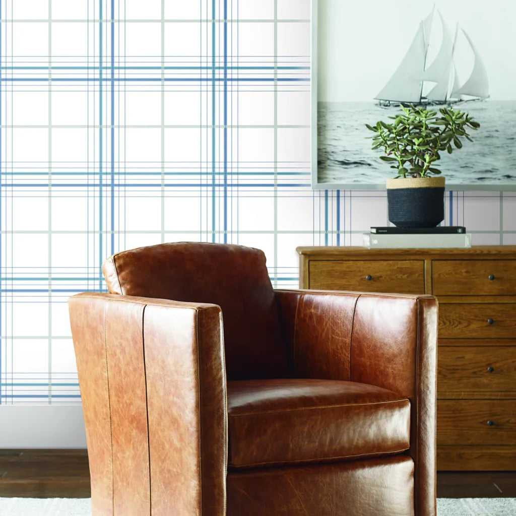 Blue & grey 'Lakeside Plaid' wallpaper by York Wallcoverings elevates a cozy living room with classic style.