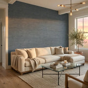Living Room - Modern living room with 'Oceanside Grass' wallpaper in Blue Grey by York Wallcoverings creating a serene space.