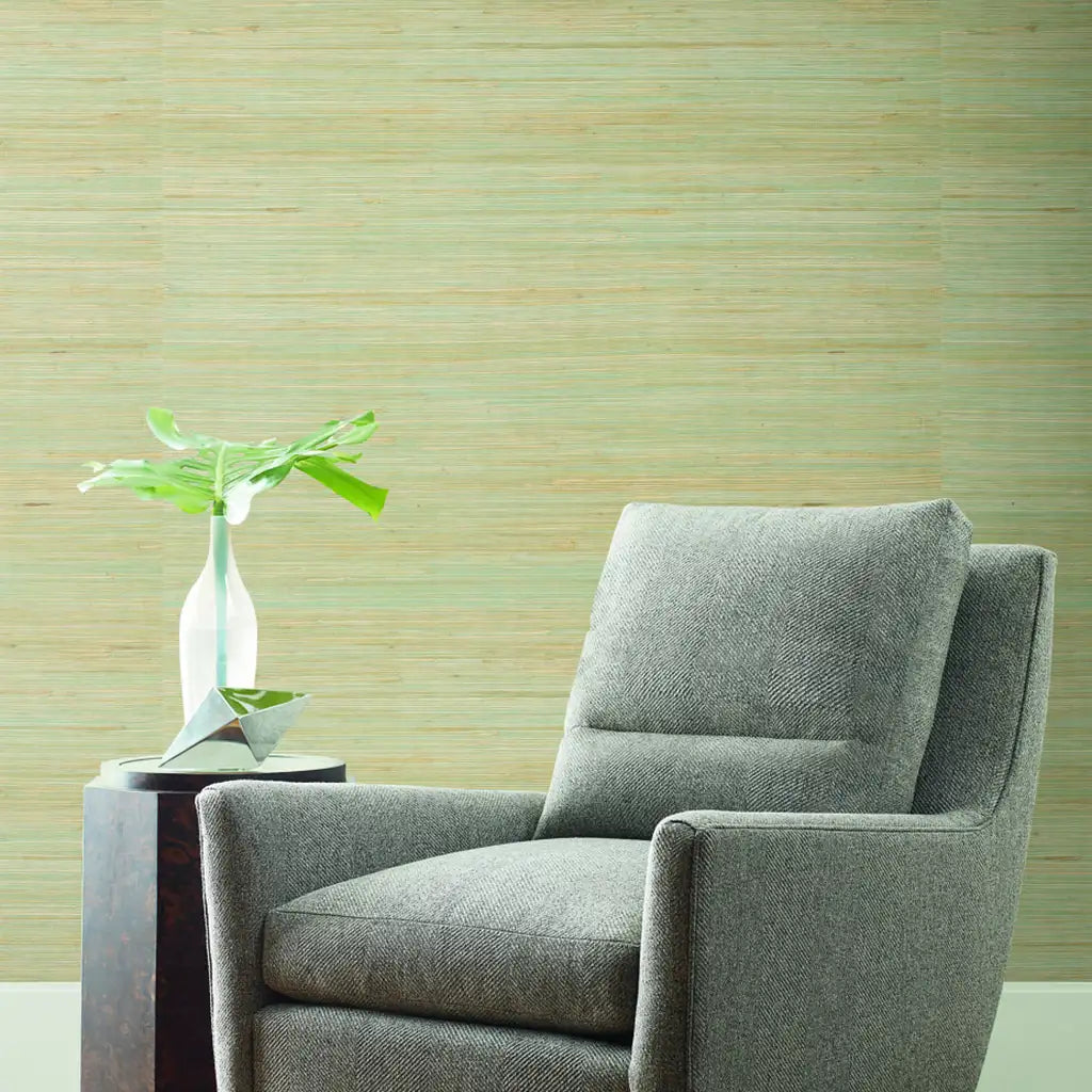 Experience coastal calm in this living room, featuring Seafoam and Tan Oceanside Grass wallpaper by York Wallcoverings.