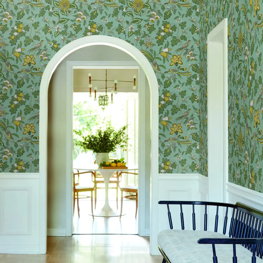 An inviting entryway features York Wallcoverings' Parterre wallpaper in Grey, Green, Yellow for a stylish first impression.