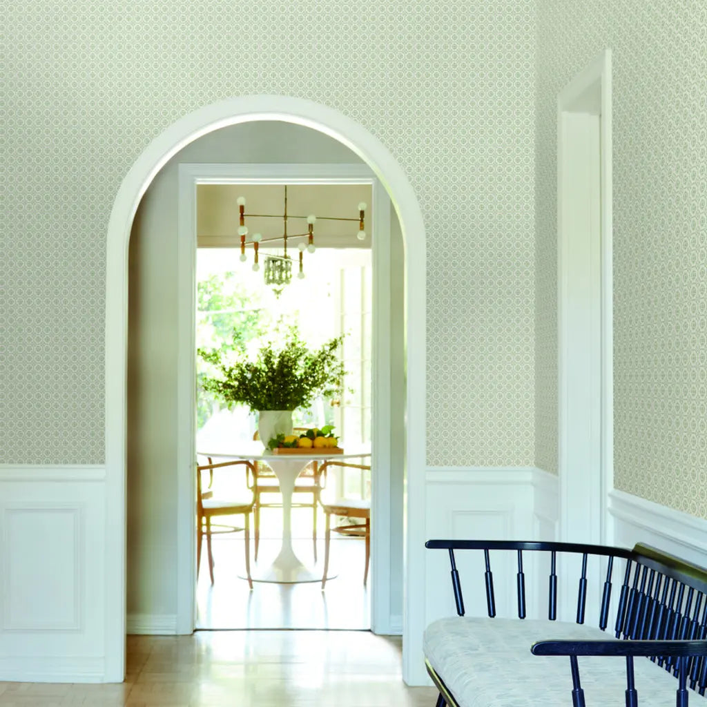 Green and White Priti wallpaper by York Wallcoverings brightens this stylish entryway, offering a fresh, inviting welcome.