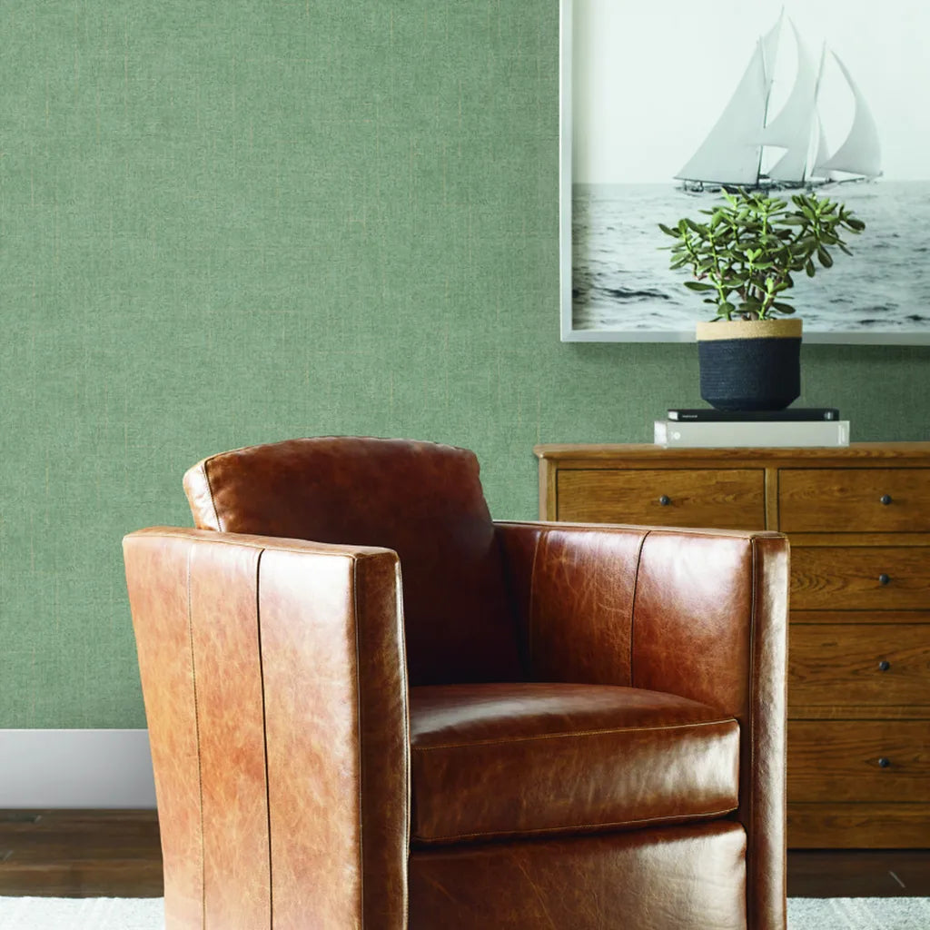 Elegant living room showcases Saratoga Sage Green wallpaper by York Wallcoverings, adding a touch of serene style.