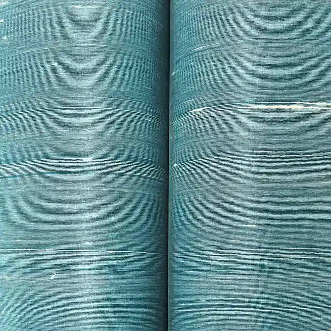 Close-up texture of York Wallcoverings' 'Silk Road' wallpaper in Dusty Blue, highlighting its intricate, luxurious fabric-like detail.