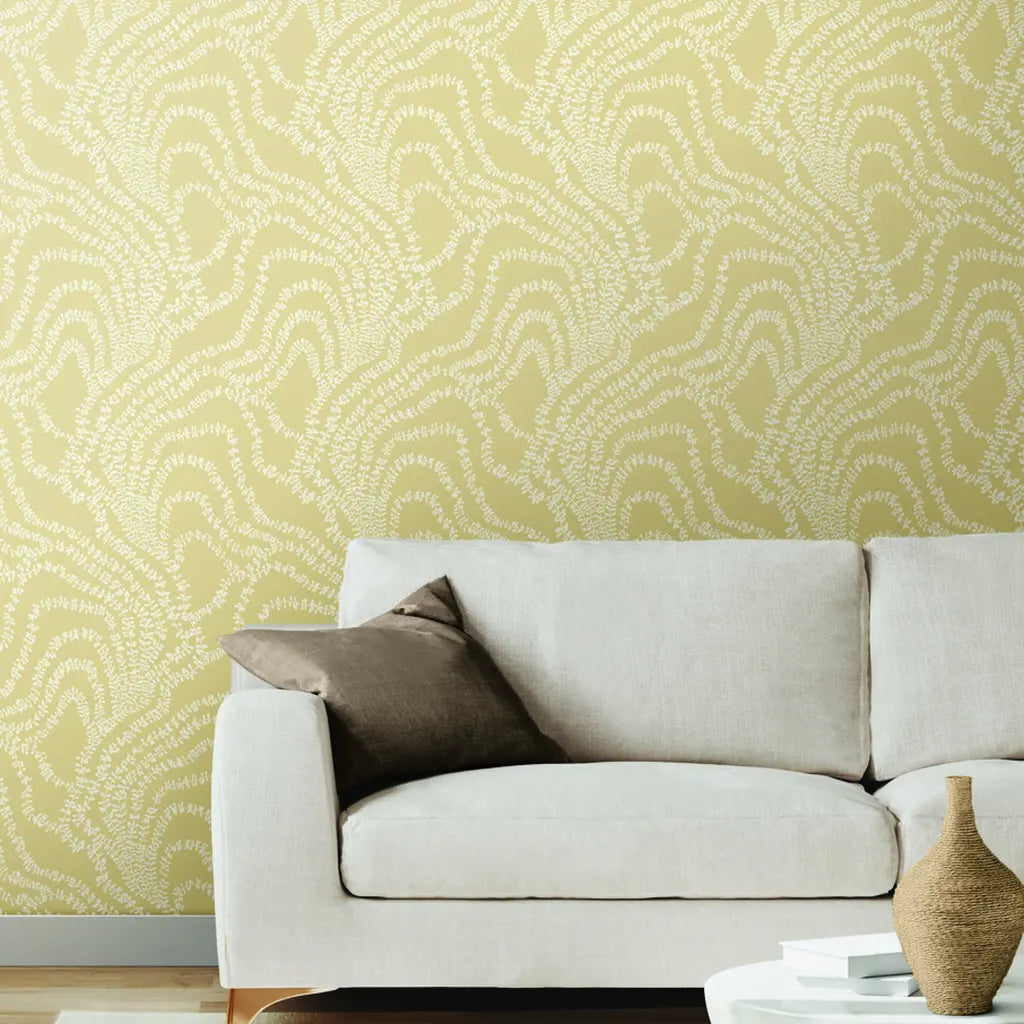 Elegant living room features Warm Beige String of Pearls wallpaper by York Wallcoverings, adding botanical charm.