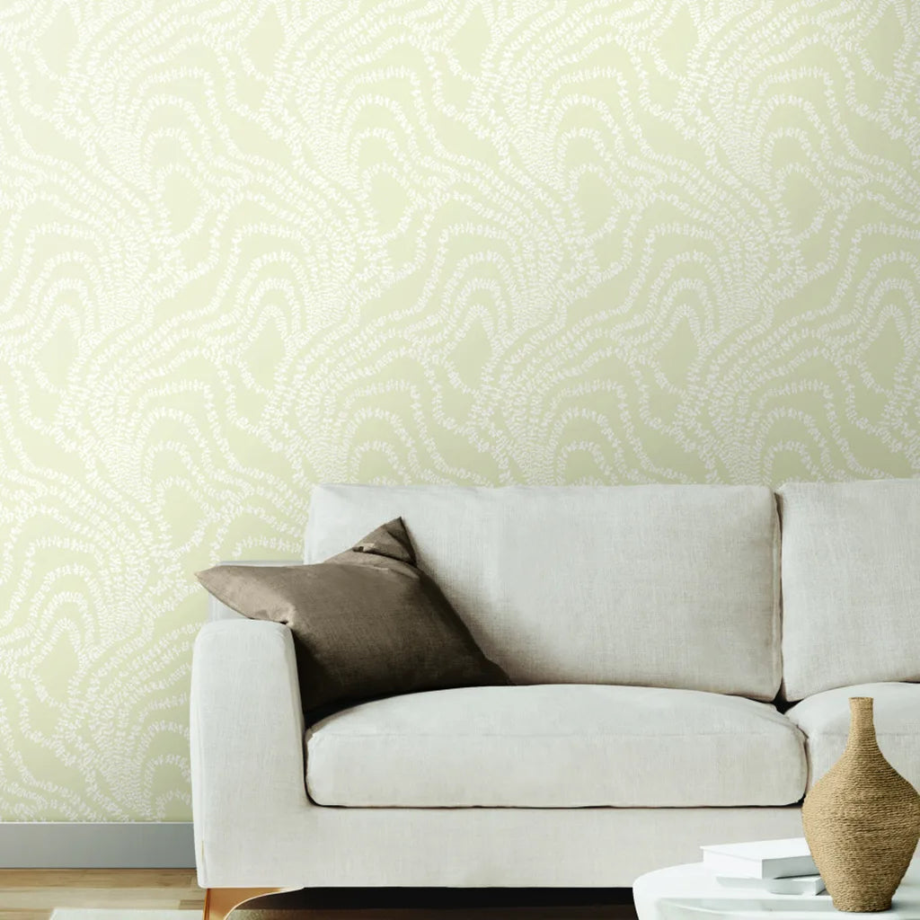 Elegant living room features Warm Ivory 'String of Pearls' wallpaper by York Wallcoverings, adding subtle texture and light.
