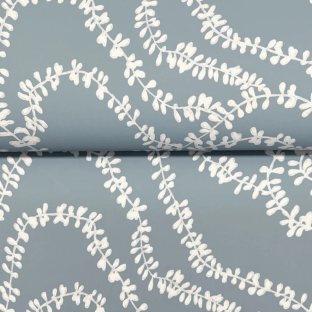 Close-up of Dusty Blue 'String of Pearls' wallpaper texture by York Wallcoverings, revealing intricate details.