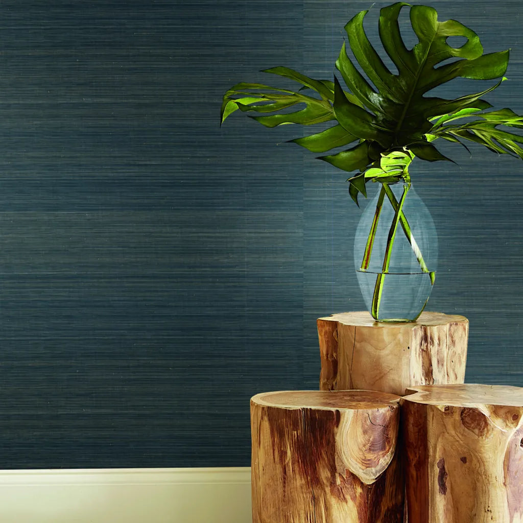 Modern living room features luxurious Teal and Gold 'Tailored Abaca' wallpaper by York Wallcoverings, adding a sophisticated touch.