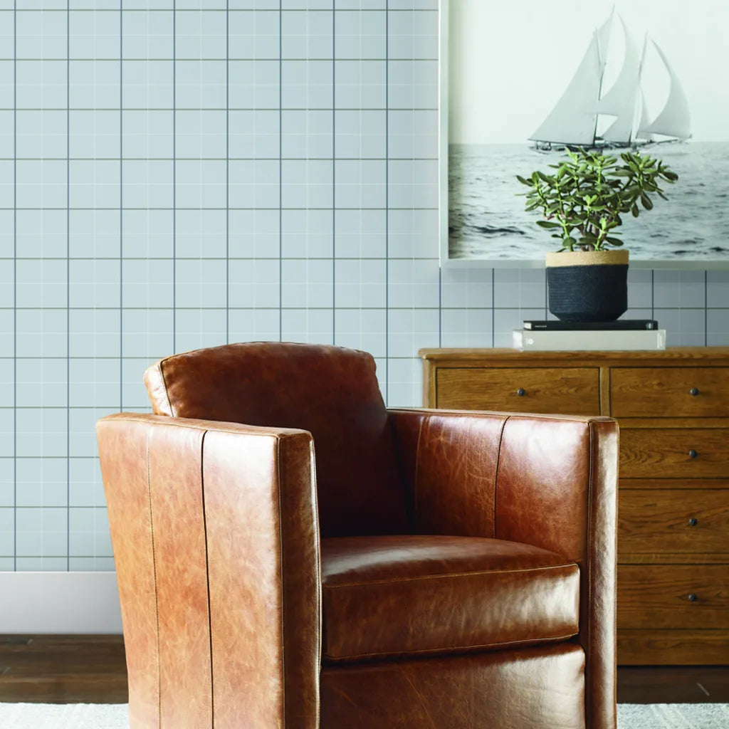 Light Grey Tattersall wallpaper by York Wallcoverings enhances this cozy living room, adding sophisticated texture and style.