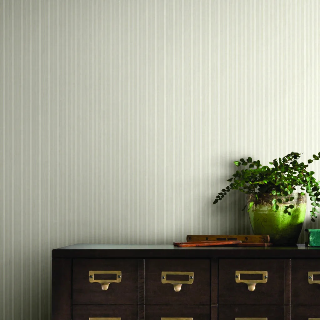 Warm Ivory Ticking Stripe wallpaper by York Wallcoverings adds classic charm to this inviting home office.