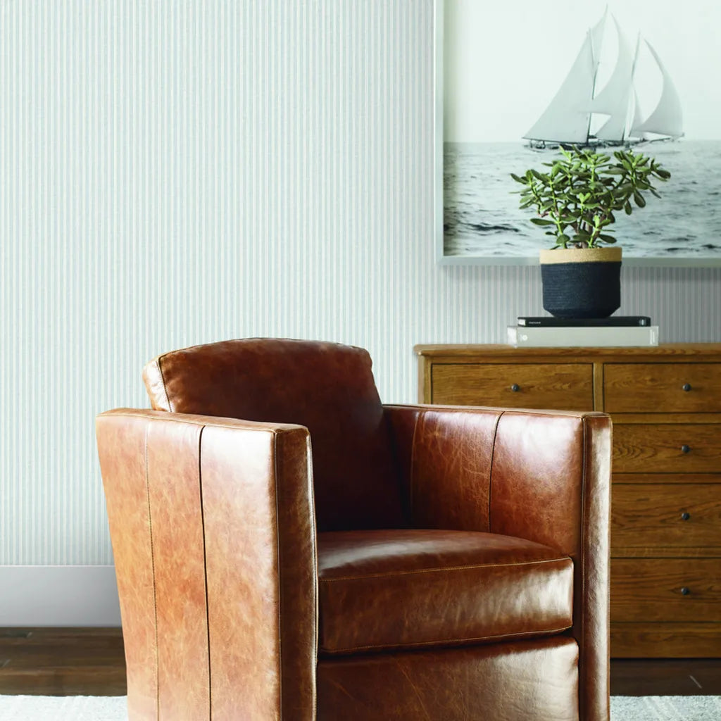 Cozy living room featuring classic Pale Blue and White Ticking Stripe wallpaper by York Wallcoverings, creating a fresh, inviting space.