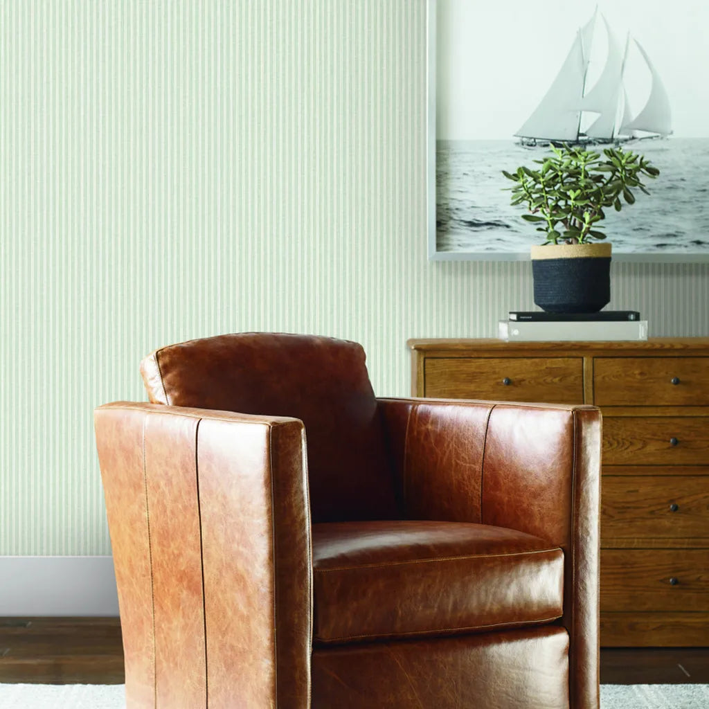 Cozy living room with Sage Green Ticking Stripe wallpaper by York Wallcoverings, adding classic style to the space.