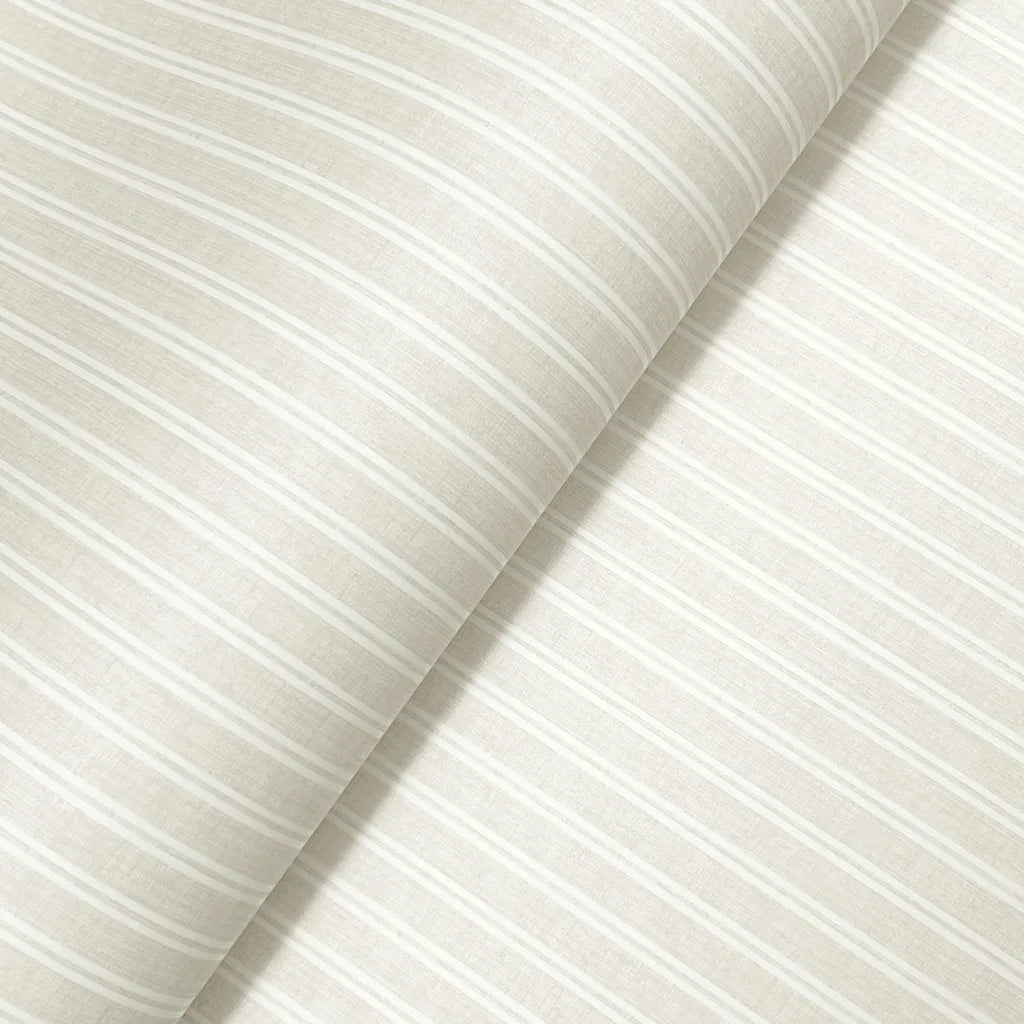Close-up texture detail of York Wallcoverings' Warm Ivory Ticking Stripe wallpaper, highlighting its subtle woven pattern.