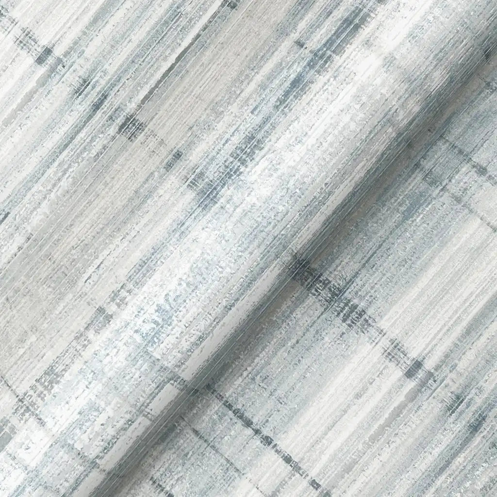 Textured close-up of York Wallcoverings' Vanishing Point wallpaper, highlighting the intricate blue, grey, and white pattern.