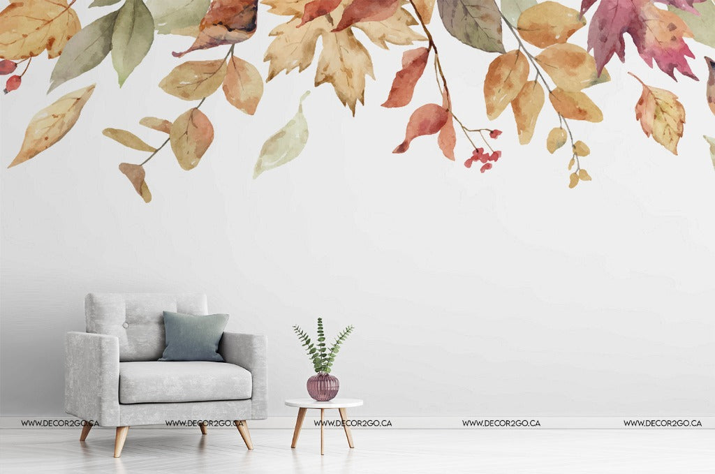 Living Room - A modern minimalist living room with a gray armchair and a small round table with a potted plant. The wall behind is adorned with large, colorful Falling Leaves Wallpaper Mural decals from Decor2Go Wallpaper Mural.