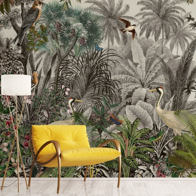 A bright yellow chair stands in front of a Decor2Go Wallpaper Mural featuring lush greenery and various birds. To add character, a vintage-style white floor lamp is positioned to the left of the chair.