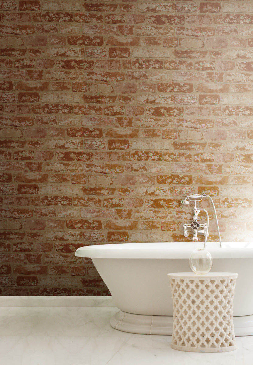 Bathroom - The image shows a modern with a vintage style. It features a white freestanding bathtub with a silver faucet and a decorative white basket nearby. The wall behind the tub is adorned with York Wallcoverings Urban Chic Up The Wall Wallpaper (56 SqFt), adding an element of architectural décor to the space