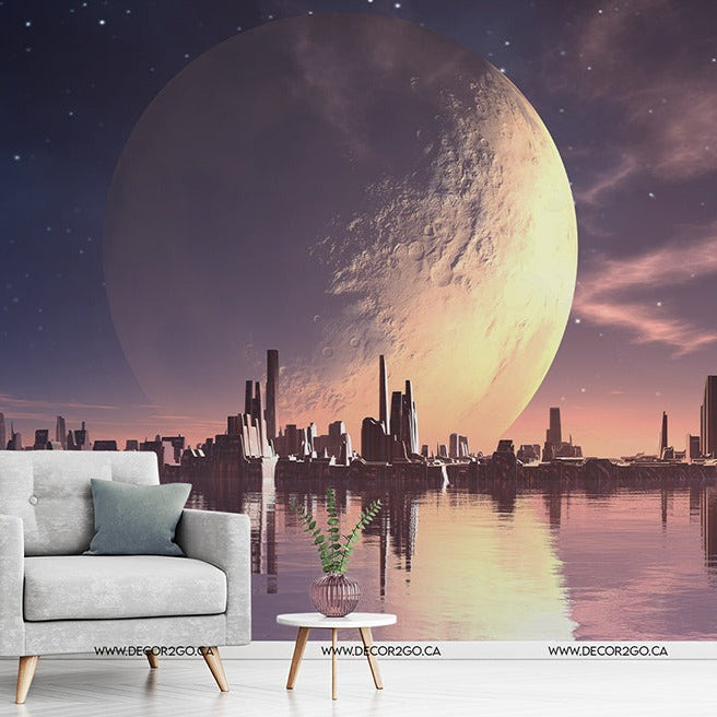 A surreal digital artwork depicting a large moon hovering above a reflective ocean and a city skyline at sunrise, with an armchair and table with a plant in the foreground. This piece is available as an Decor2Go Wallpaper Mural Eden Prime.