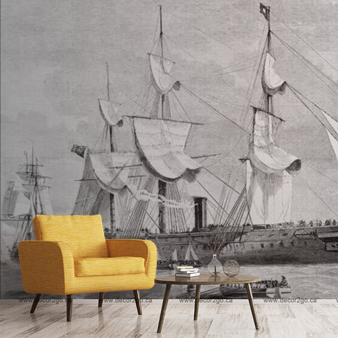 Living Room - A modern living room with a bright orange armchair and a small wood table, in front of a large black and white mural of Decor2Go Wallpaper Mural sailing ships, inspired by classic pirate stories.