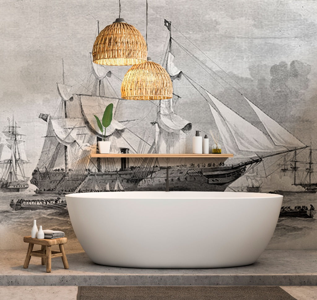 Bathroom - A minimalist bathroom featuring a white freestanding bathtub, a wooden stool with towels and bottles, and two wicker pendant lights. The backdrop is the Decor2Go Wallpaper Mural's Sailing Away Wallpaper Mural of an old sailing ship in grayscale, adding serene seascape vibes to the nautical-themed modern space.