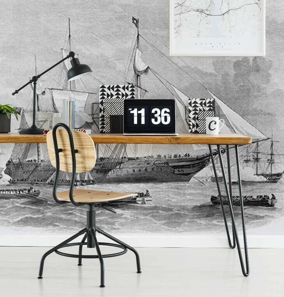 Home Office - A stylish home office featuring a wooden desk with hairpin legs, a laptop displaying the time, a potted plant, and books. Decor2Go's Sailing Away Wallpaper Mural provides a nautical vibe.