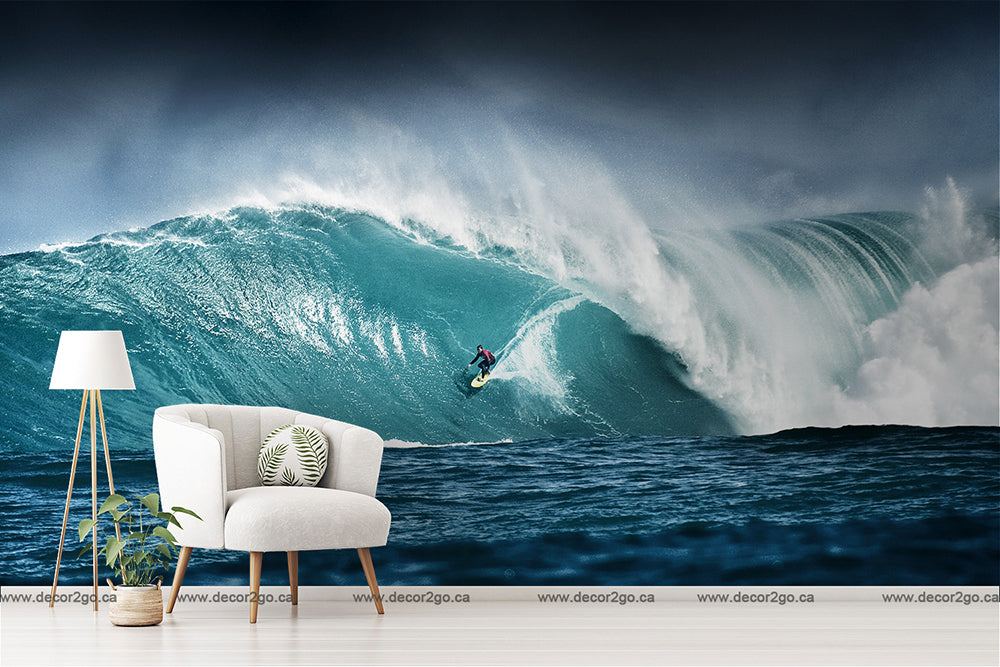 A surreal image of an indoor space with a white armchair and lamp, against a vivid Decor2Go Wallpaper Mural depicting a large blue wave with a surfer riding it.