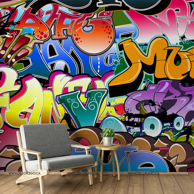 Living Room - Modern living room with a minimalist gray chair and wooden side table against a vibrant, colorful Decor2Go Wallpaper Mural featuring various abstract designs and shapes.
