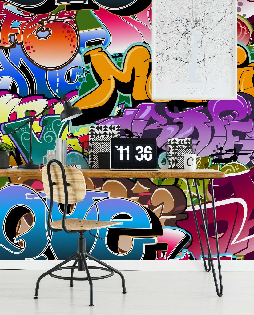 A modern workspace with a desk and swivel chair against a vibrant Urban Colors Wallpaper Mural from Decor2Go Wallpaper Mural. The desk features a minimalist clock and a framed abstract art piece above.