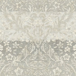 A detailed, intricate pattern featuring floral and leaf motifs in varying shades of grey and white. The design appears vintage and decorative, giving a textured, almost fabric-like appearance with ornamental and symmetrical elements throughout, reminiscent of York Wallcoverings' Patina Vie Zara Damask Wallpaper - Grey elegance.