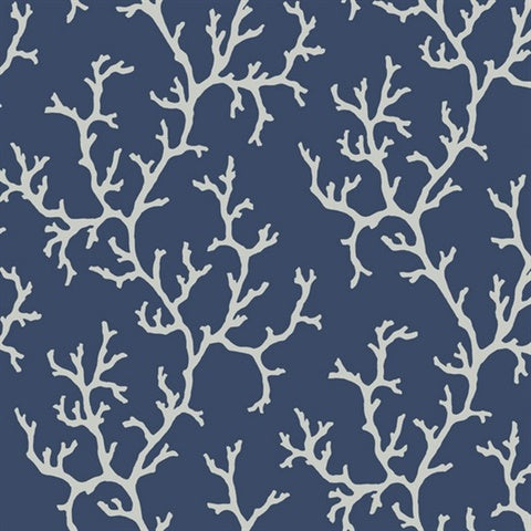 A seamless pattern featuring white coral branches on a navy blue background. The intricate coral shapes create a striking contrast against the dark backdrop, giving the Coral Island (60 SqFt) by York Wallcoverings a marine-themed and elegant appearance. This vinyl-coated, washable, and strippable wallpaper is perfect for any space.