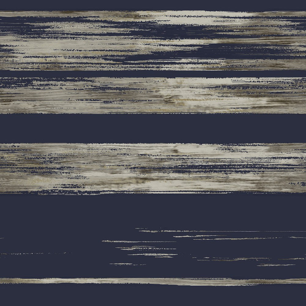 Abstract artwork featuring horizontal dry brushstrokes in various shades of blue, gray, and beige. The brushstrokes create a layered, textured effect against a dark navy roll wallpaper background, with a mix of thick and thin lines giving a sense of movement and depth. This is the Dry Brush Wallpaper (60 SqFt) by York Wallcoverings.