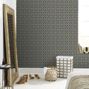 Laundry Room - A modern bedroom corner features a large mirror with an ornate frame leaning against the wall, black and gold Facet Geometric Wallpaper by York Wallcoverings, a white basket with a woven design, and a pair of tan shoes on the white wooden floor